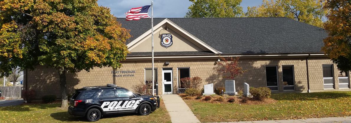 police department building american flag police car